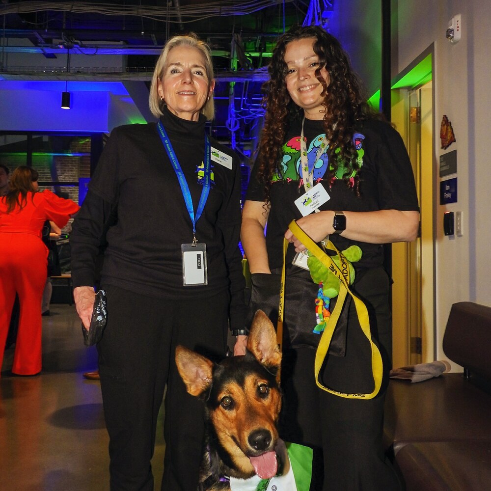 Volunteers with a featured dog at Evening for Animals